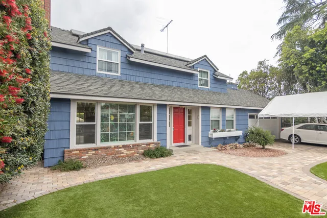 a front view of a house with a yard and porch