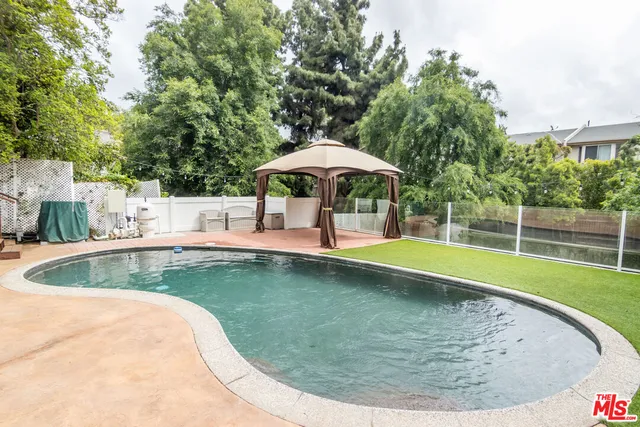 a view of a swimming pool with a patio