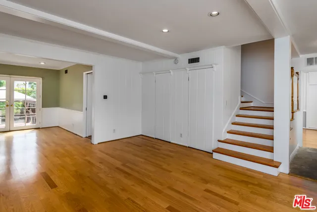 a view of a room with wooden floor and stairs