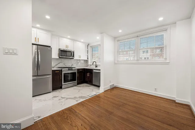 a kitchen with stainless steel appliances a refrigerator sink and microwave