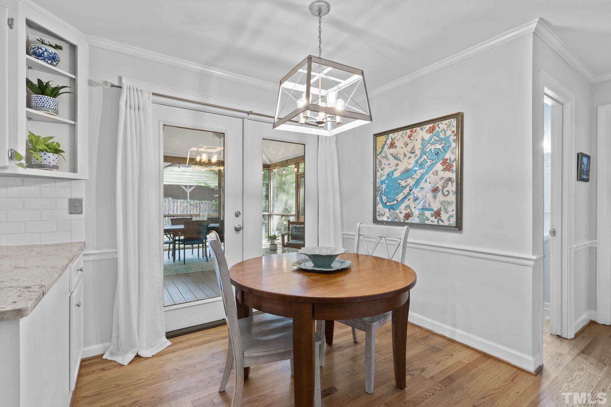 3412 Wembley Court Raleigh, NC 27607 - Photo 13 of 46 a view of a dining room with furniture window and wooden floor