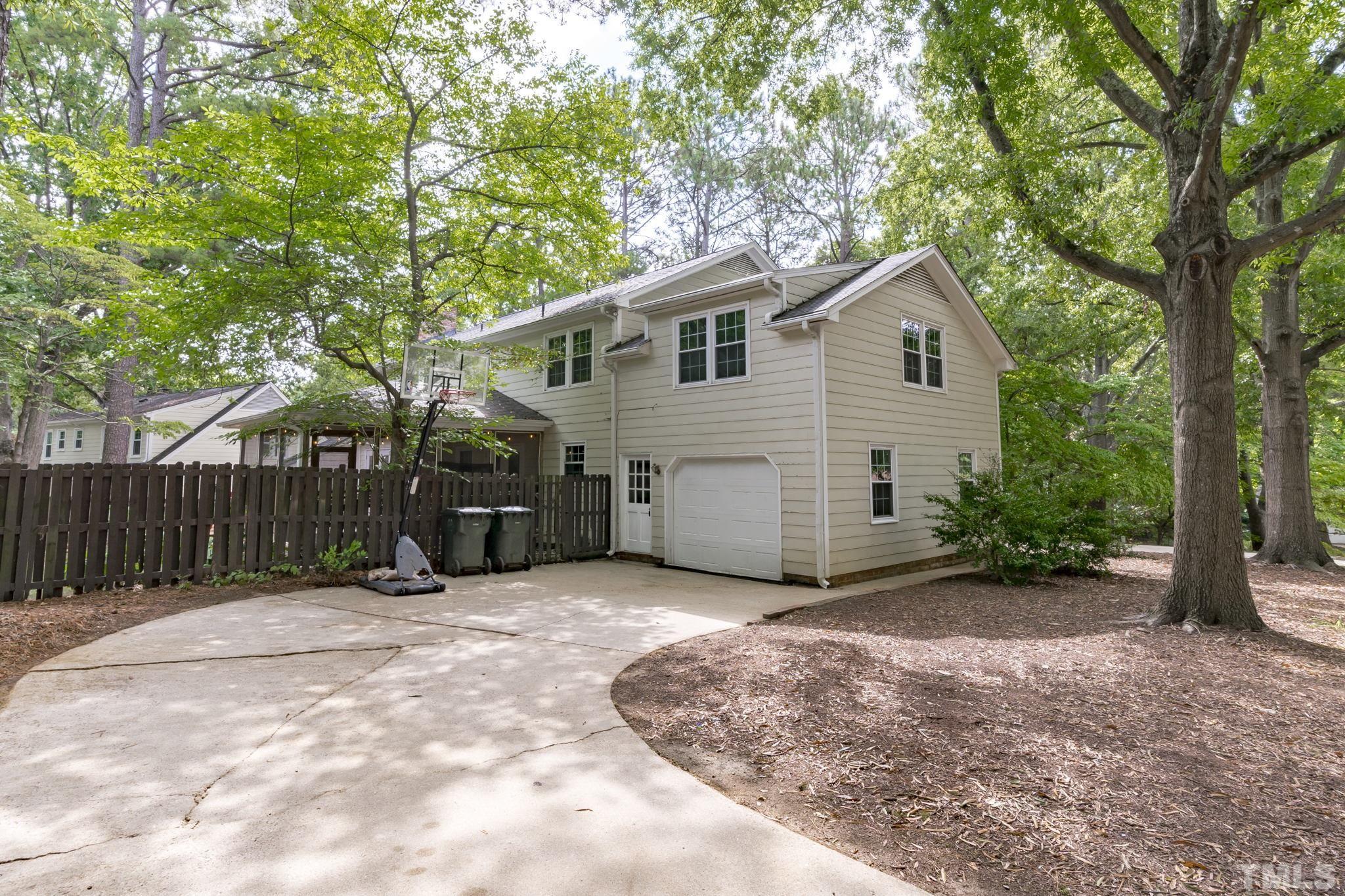 3412 Wembley Court Raleigh, NC 27607 - Photo 43 of 46 a view of a house with a small yard and large trees