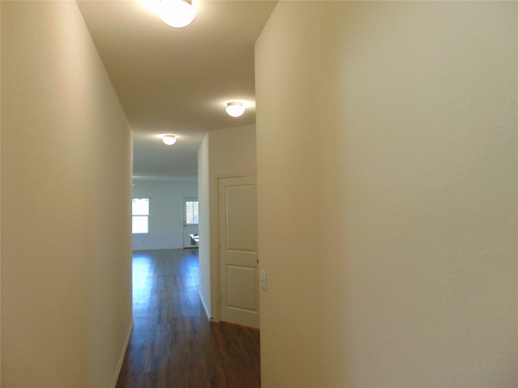 181 Crystal River Road Kyle, TX 78640 - Photo 3 of 12 a view of a hallway with wooden floor