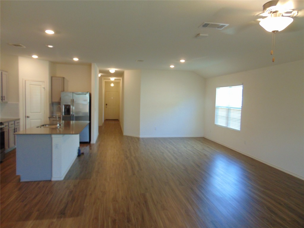 181 Crystal River Road Kyle, TX 78640 - Photo 12 of 12 a view of a kitchen with wooden floor and a window