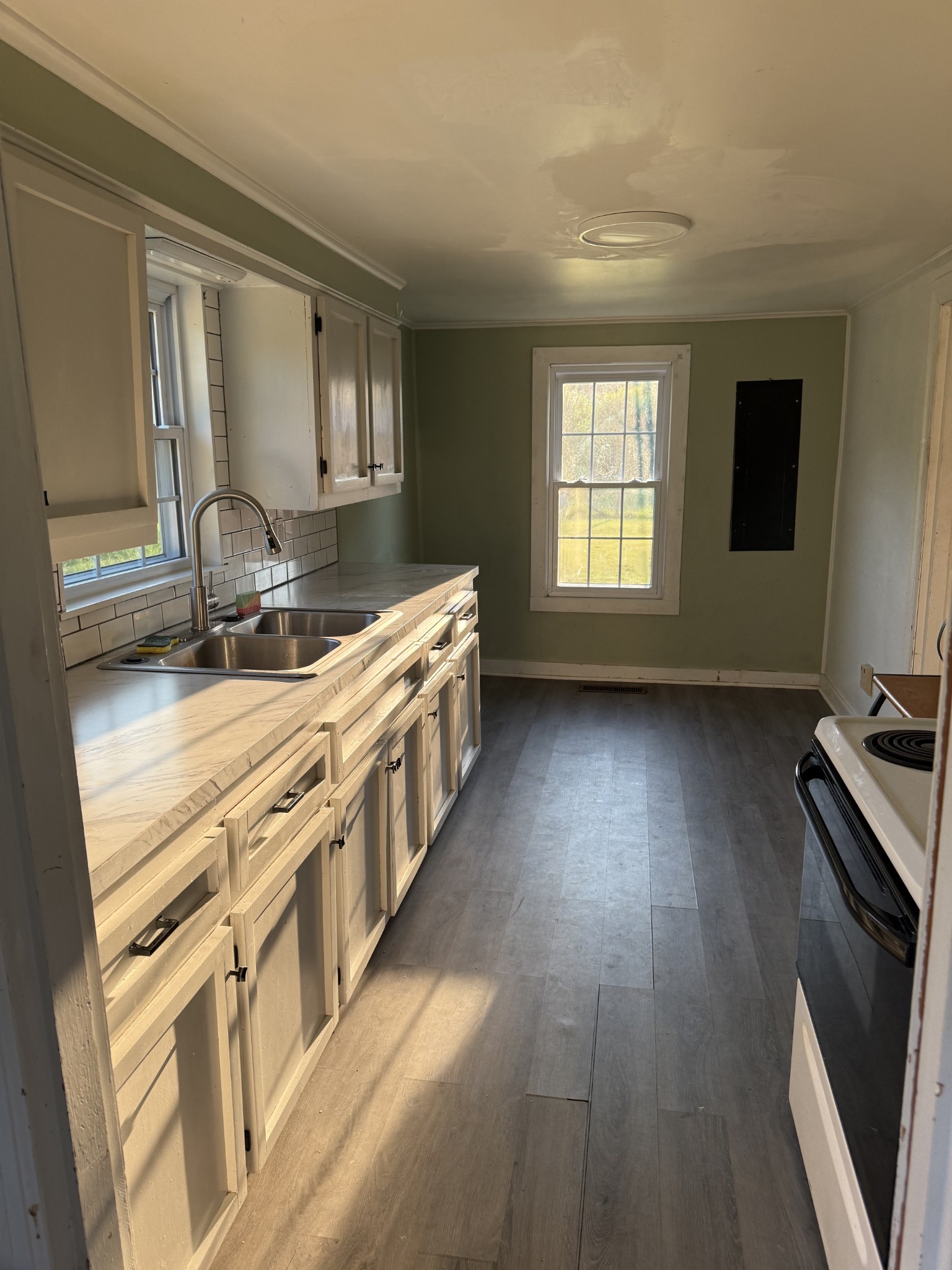520 Pumpkin Branch Road Dixon Springs, TN 37057 - Photo 11 of 36 a kitchen with stainless steel appliances a sink stove and cabinets