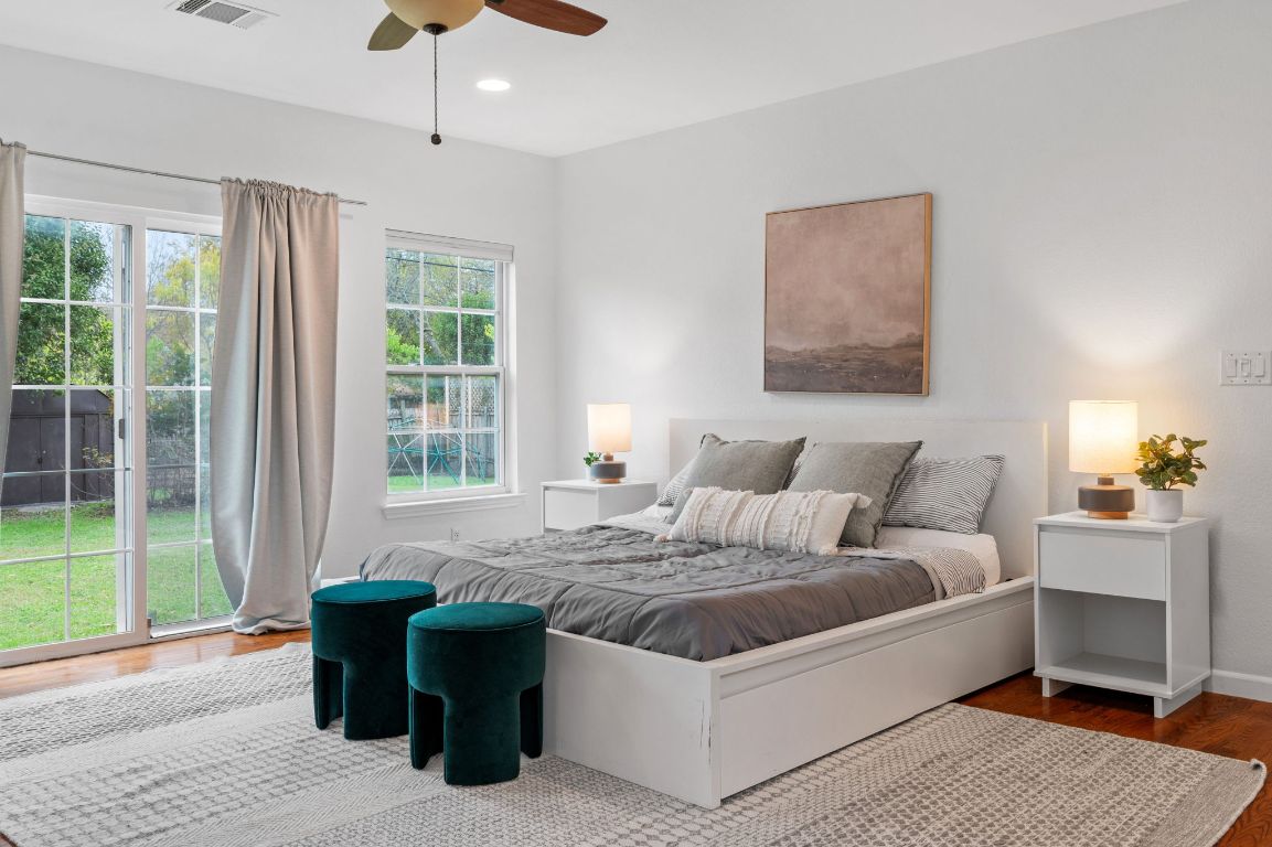 7517 Delafield Lane Austin, TX 78752 - Photo 14 of 39 Bedroom with access to outside, wood finished floors, a ceiling fan, and recessed lighting