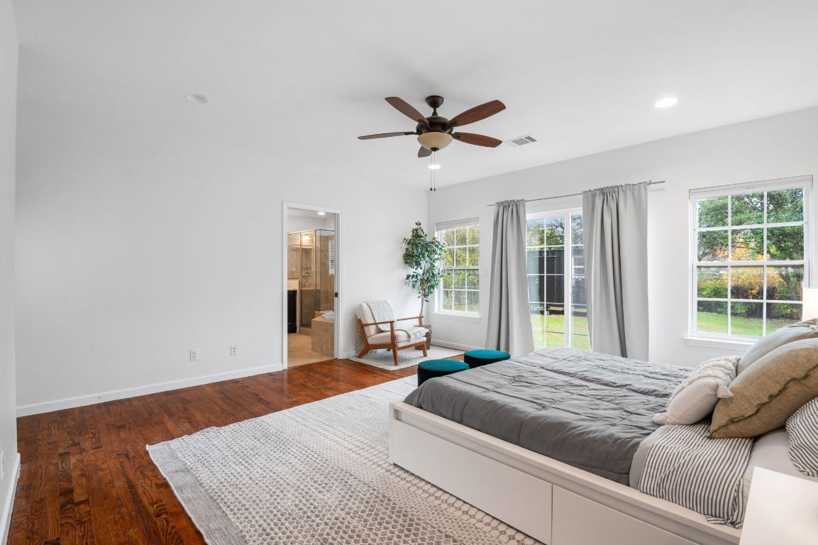 7517 Delafield Lane Austin, TX 78752 - Photo 15 of 39 Bedroom featuring dark wood finished floors, ensuite bath, ceiling fan, and recessed lighting