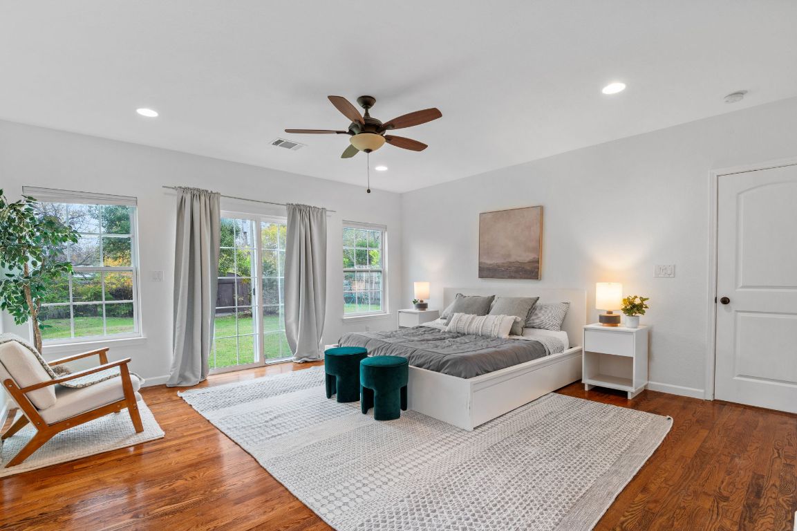 7517 Delafield Lane Austin, TX 78752 - Photo 18 of 39 Bedroom featuring access to exterior, dark wood-style flooring, recessed lighting, and a ceiling fan