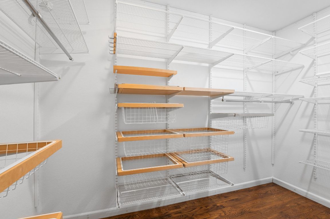 7517 Delafield Lane Austin, TX 78752 - Photo 30 of 39 Spacious closet with dark wood finished floors