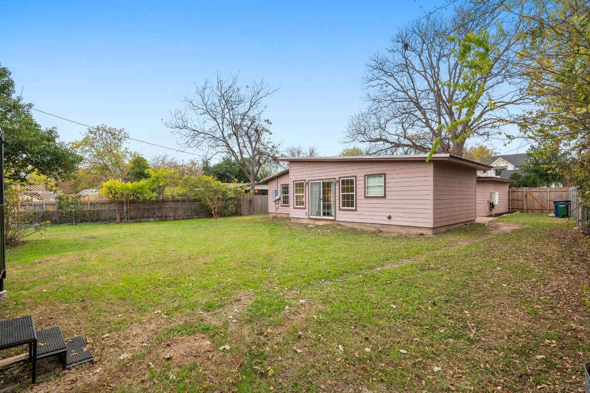 7517 Delafield Lane Austin, TX 78752 - Photo 35 of 39 Rear view of house with a fenced backyard