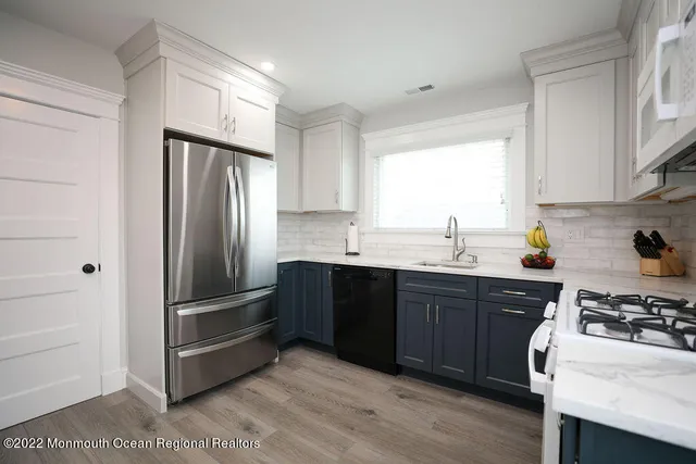 a kitchen with a refrigerator stove and sink