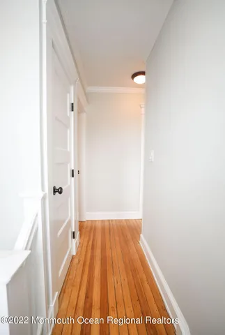 a view of a bedroom with cabinet mirror and window