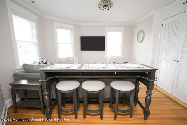 a kitchen with granite countertop a sink and chairs