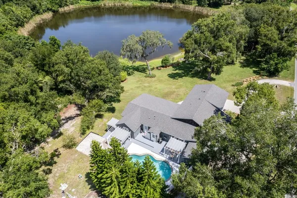 an aerial view of a house with a lake view
