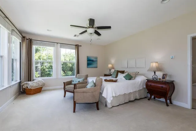 a bedroom with furniture and a large window