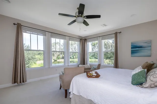 a bed sitting in a bedroom next to a window