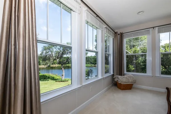 a view of a room with a bed and large windows