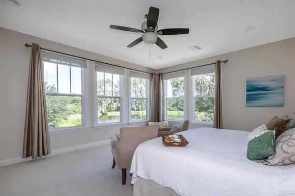 a bed sitting in a bedroom next to a window
