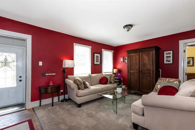 a living room with furniture a rug and a window