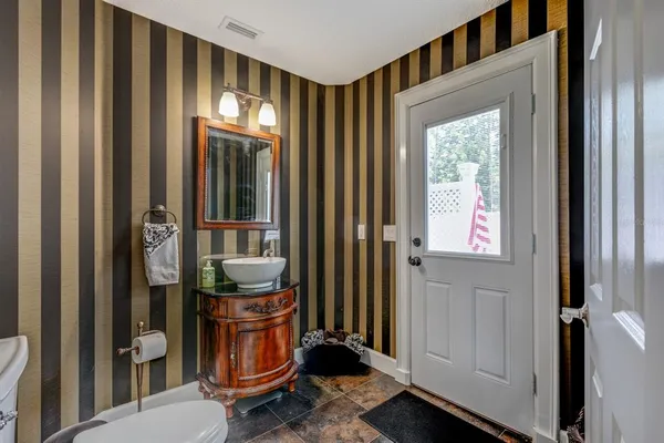 a bathroom with a toilet a sink and mirror