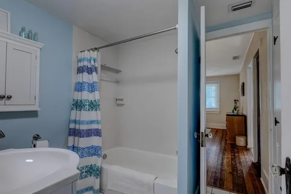 a bathroom with a bathtub and a sink