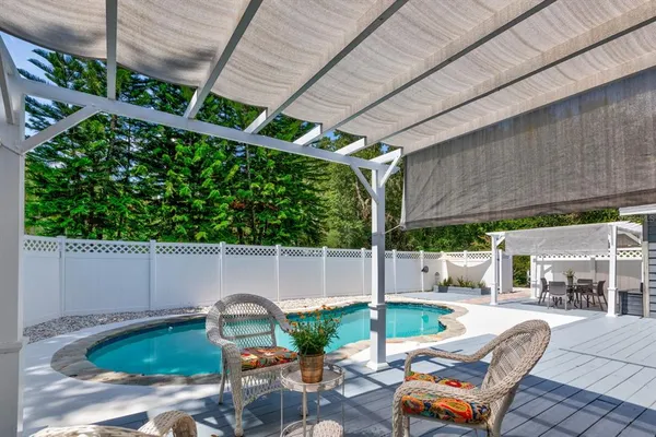 a backyard of a house with outdoor seating