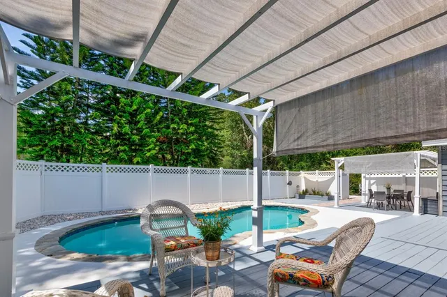 a backyard of a house with outdoor seating