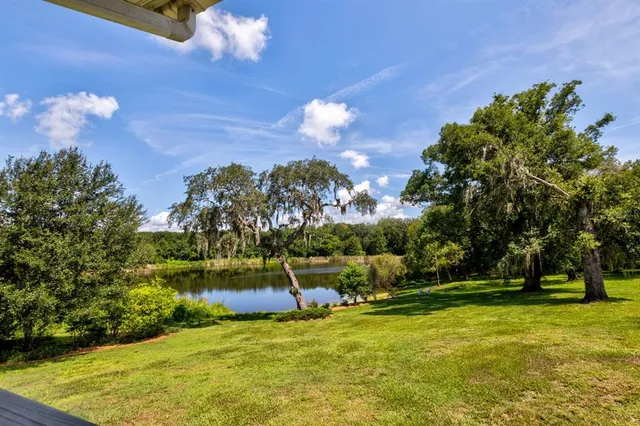 an aerial view of a house with yard and patio