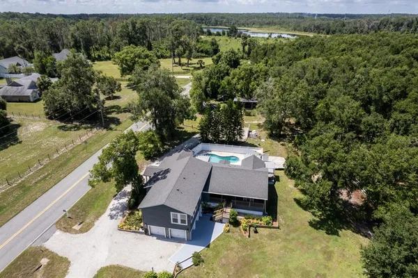 an aerial view of a house with a swimming pool