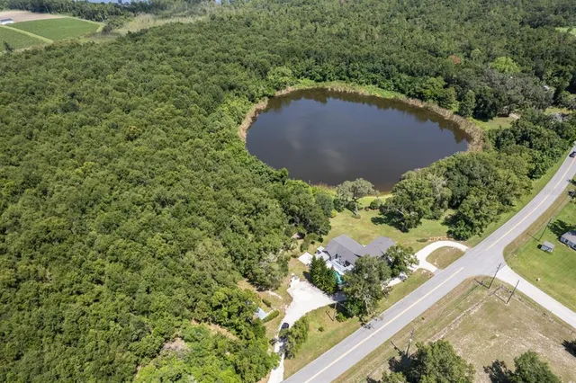 an aerial view of a house with a yard