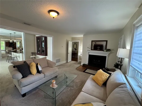 a living room with furniture and a fireplace