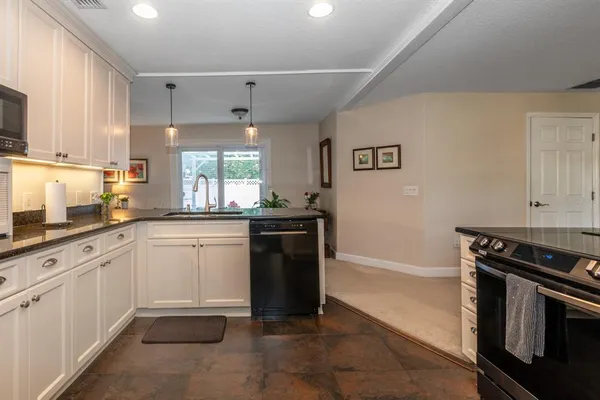 a kitchen with a sink stove and microwave