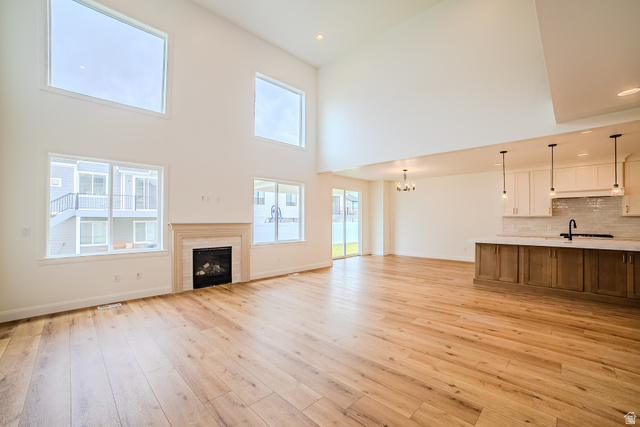 223 South Cottonwood Road, Unit 7501 Vineyard, UT 84059 - Photo 35 of 45 Spacious interior featuring high ceilings, wood-finish flooring, and a fireplace with a detailed mantel