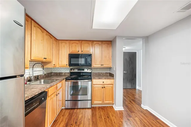 an empty room with floor to ceiling window and an outdoor view