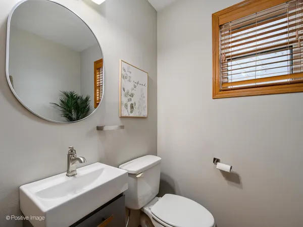 a bathroom with a sink mirror and toilet