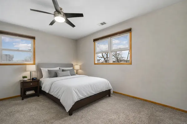 a bedroom with a bed and a painting on the wall