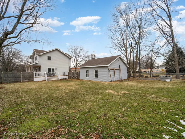 a view of a house with a backyard