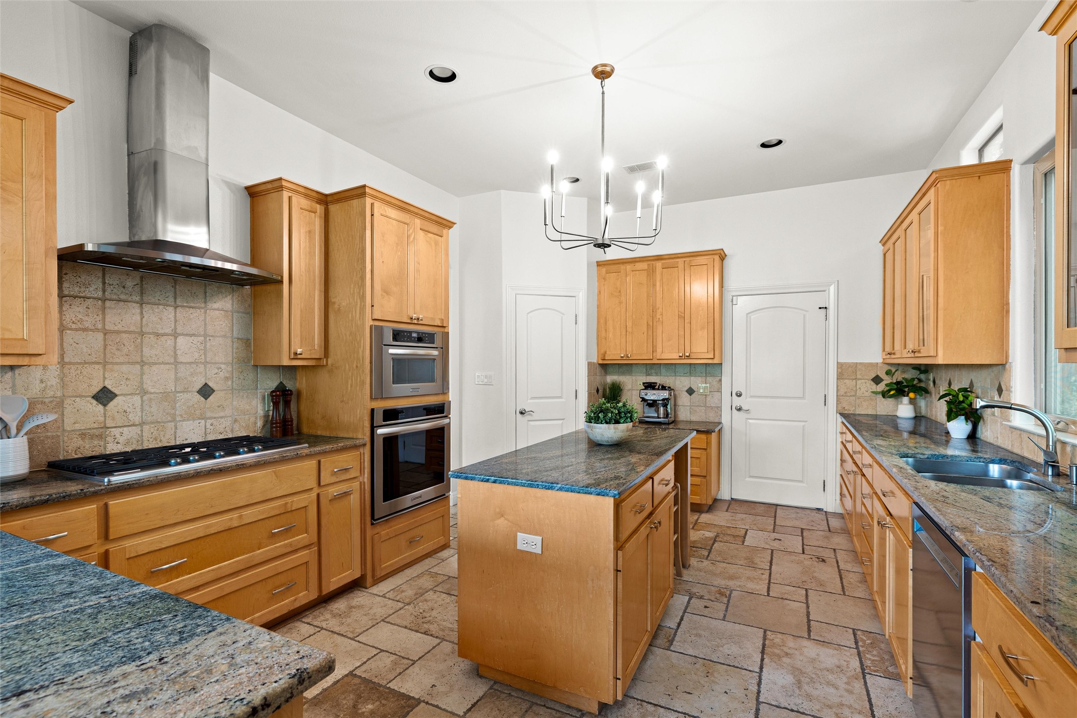 8540 Adirondack Trail, Unit 21 Austin, TX 78759 - Photo 12 of 40 a kitchen with stainless steel appliances granite countertop a sink stove and refrigerator