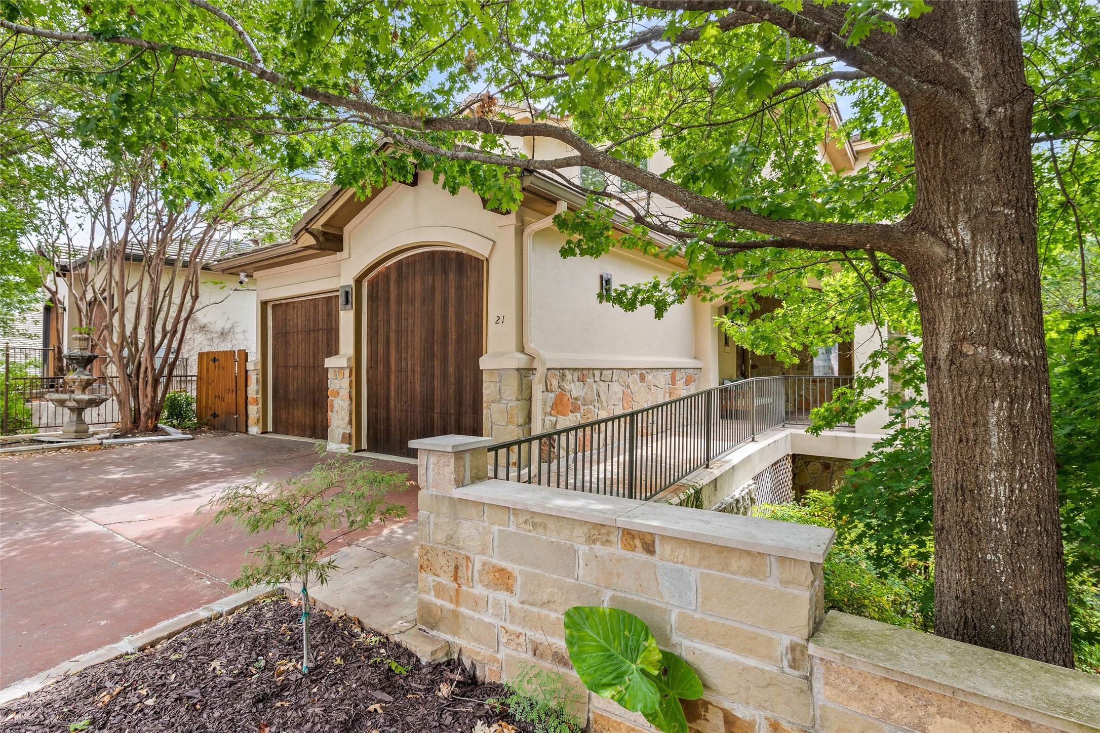 8540 Adirondack Trail, Unit 21 Austin, TX 78759 - Photo 2 of 40 a front view of a house with a garden