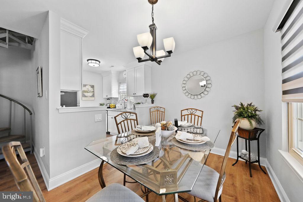 133 Tavistock Cherry Hill, NJ 08034 - Photo 11 of 35 a view of a dining room with furniture a chandelier and wooden floor