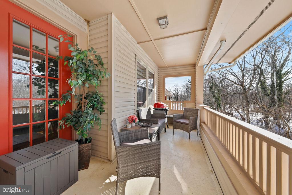 133 Tavistock Cherry Hill, NJ 08034 - Photo 14 of 35 a balcony with wooden floor and outdoor seating