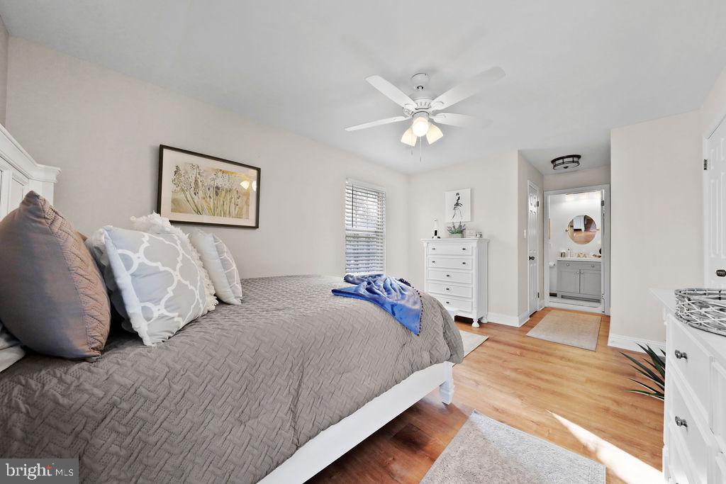 133 Tavistock Cherry Hill, NJ 08034 - Photo 18 of 35 a bedroom with a large bed and a chandelier