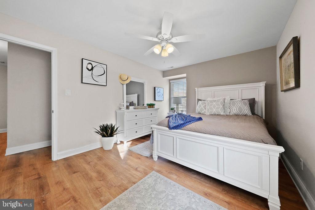 133 Tavistock Cherry Hill, NJ 08034 - Photo 19 of 35 a bedroom with a bed and a chandelier