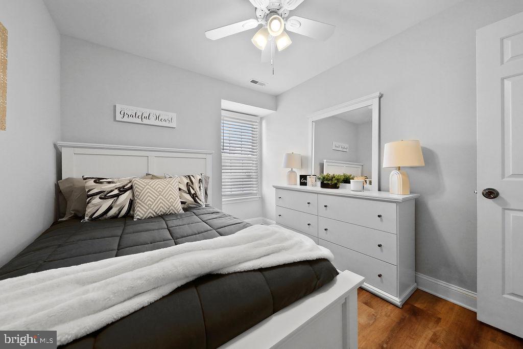 133 Tavistock Cherry Hill, NJ 08034 - Photo 23 of 35 a bedroom with a large bed and a chandelier