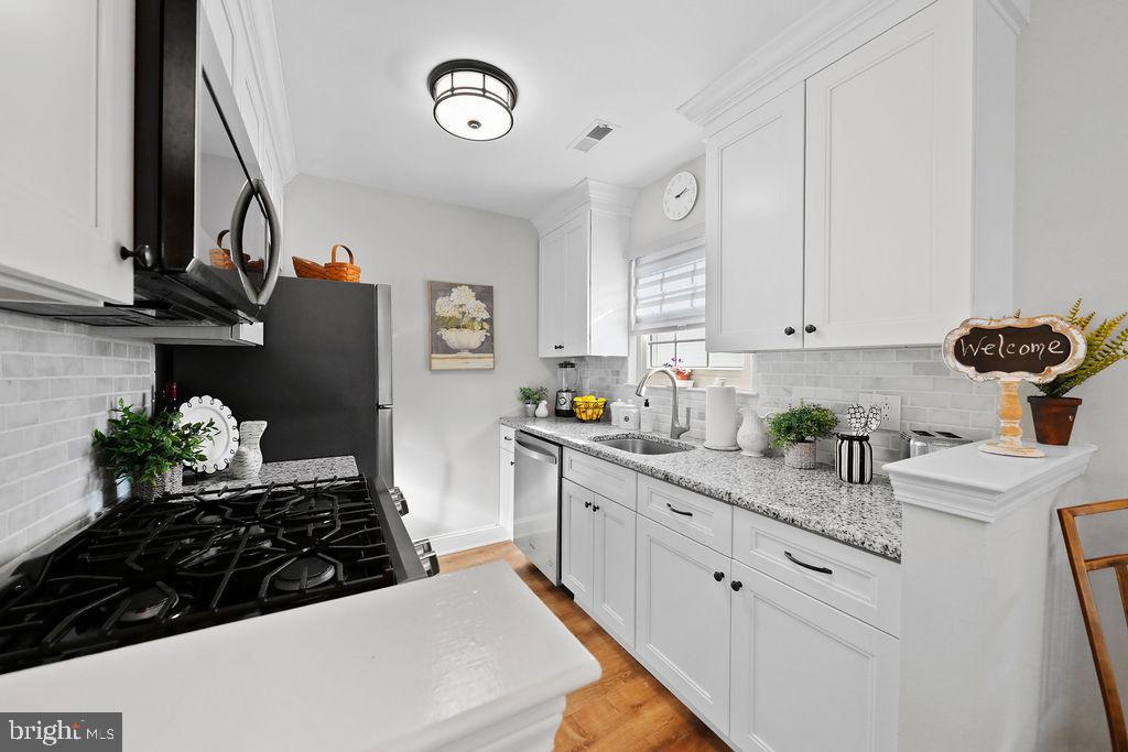 133 Tavistock Cherry Hill, NJ 08034 - Photo 3 of 35 a kitchen with stainless steel appliances kitchen island granite countertop a sink and cabinets