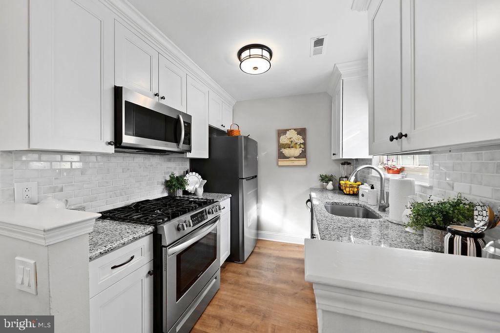 133 Tavistock Cherry Hill, NJ 08034 - Photo 5 of 35 a kitchen with granite countertop stainless steel appliances a sink a stove and cabinets