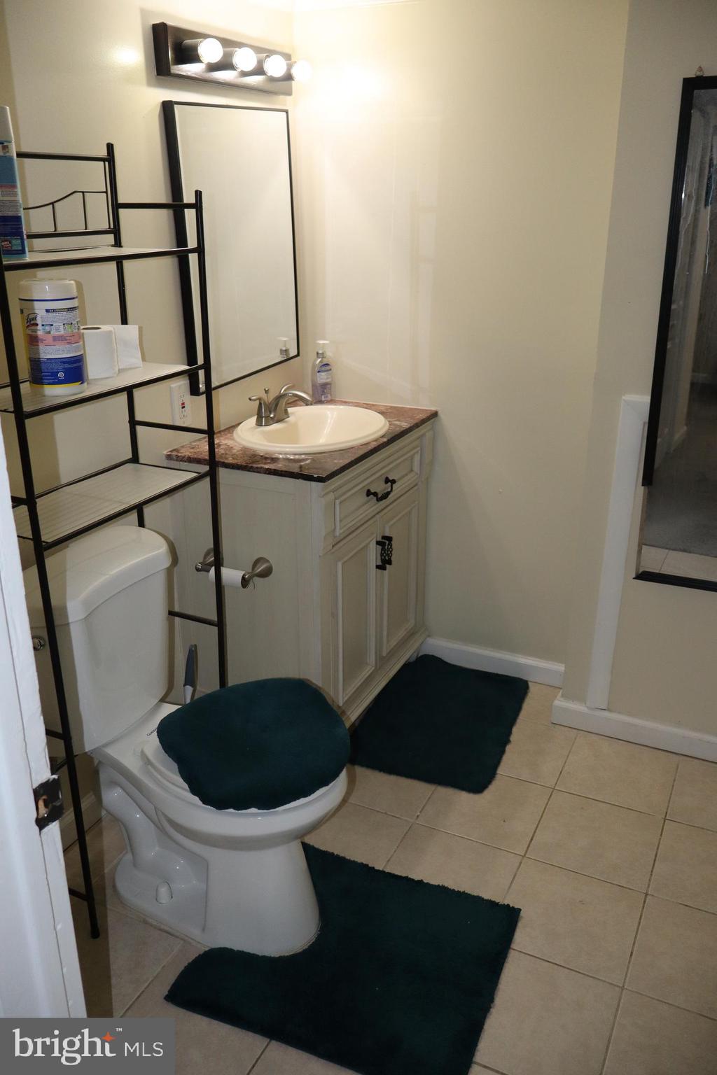 10916 Bridle Path Circle Waldorf, MD 20601 - Photo 15 of 36 a bathroom with a sink toilet and shower