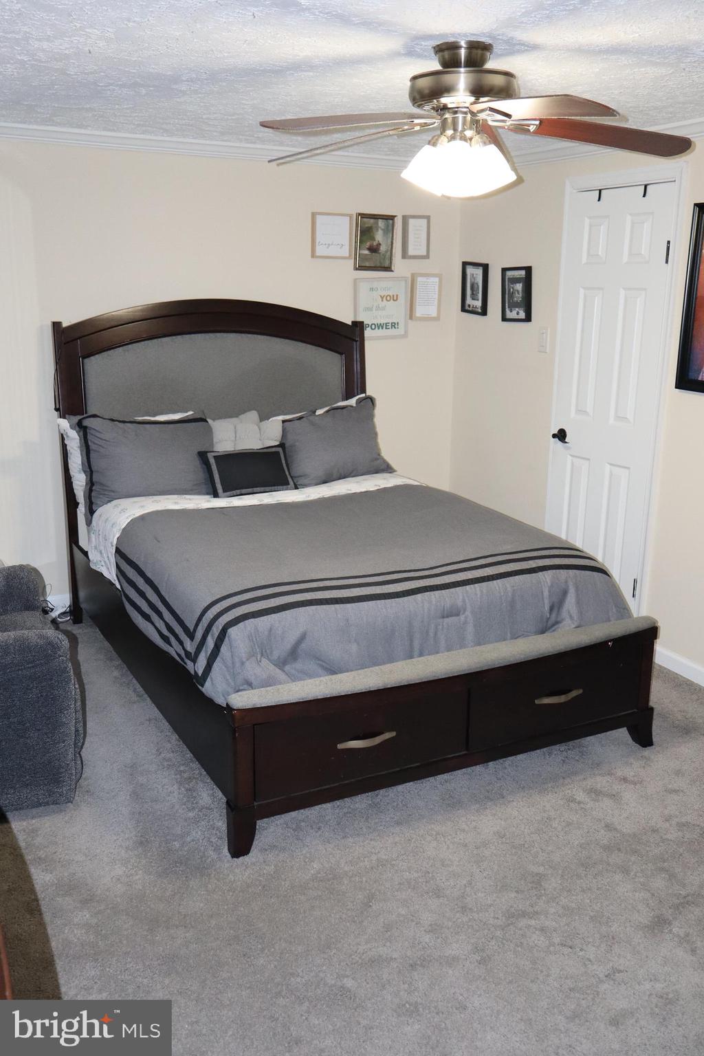 10916 Bridle Path Circle Waldorf, MD 20601 - Photo 17 of 31 a spacious bedroom with a bed and a chandelier