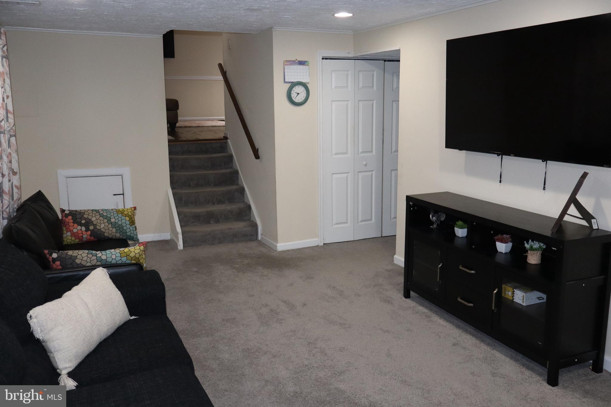 10916 Bridle Path Circle Waldorf, MD 20601 - Photo 24 of 36 a living room with furniture and a flat screen tv