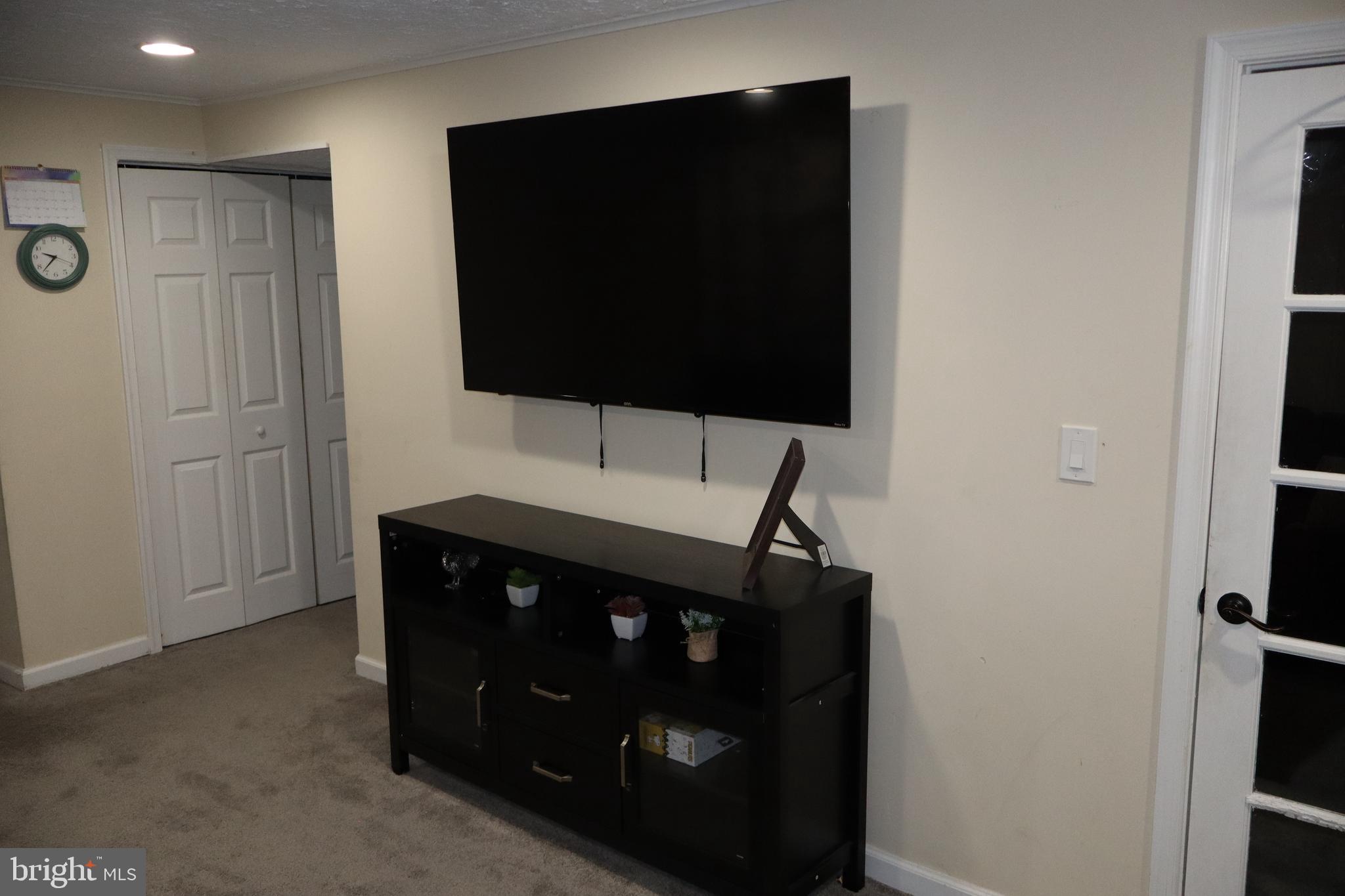 10916 Bridle Path Circle Waldorf, MD 20601 - Photo 24 of 31 a living room with a flat screen tv and a refrigerator